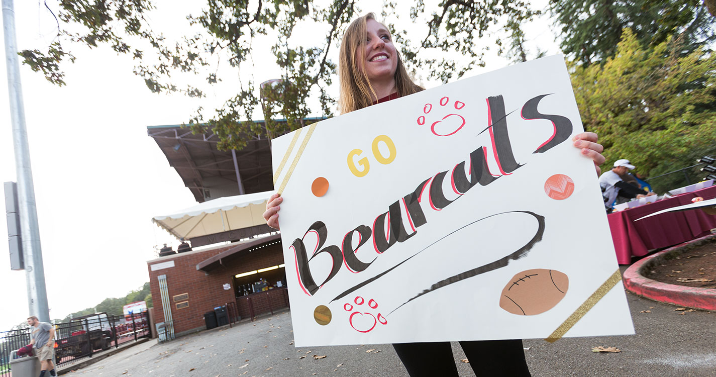 Willamette student holding a poster