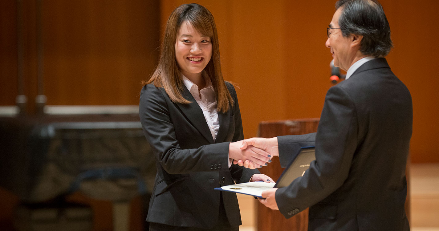 An American Studies Program student receives a certificate of completion at the program’s closing ceremony.