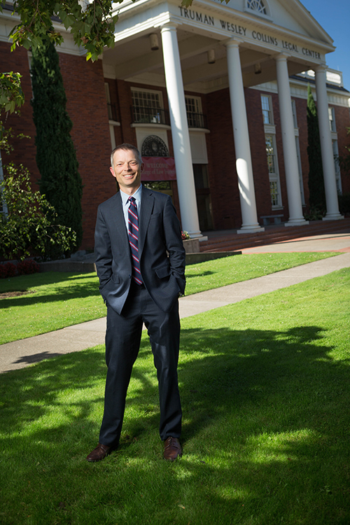 Curtis Bridgeman stands in front of the entrance to Willamette University School of Law