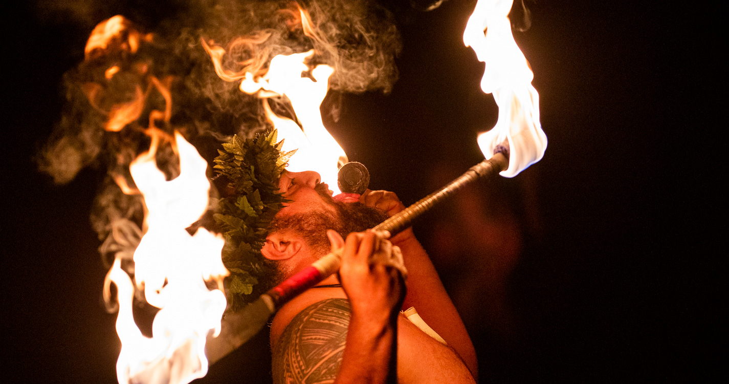 Tolo Tuitele touches a flaming baton to their tongue