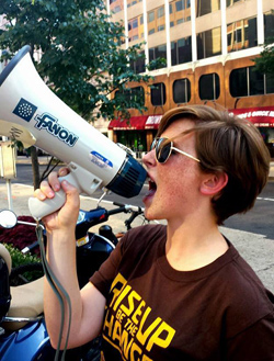 Pate '15 leads a protest in front of the Dow Chemical Company office in Washington, D.C.