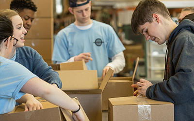 Students pack boxes as part of Willamette’s Global Day of Service