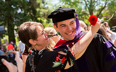 Law graduate gets embraced by woman with a rose